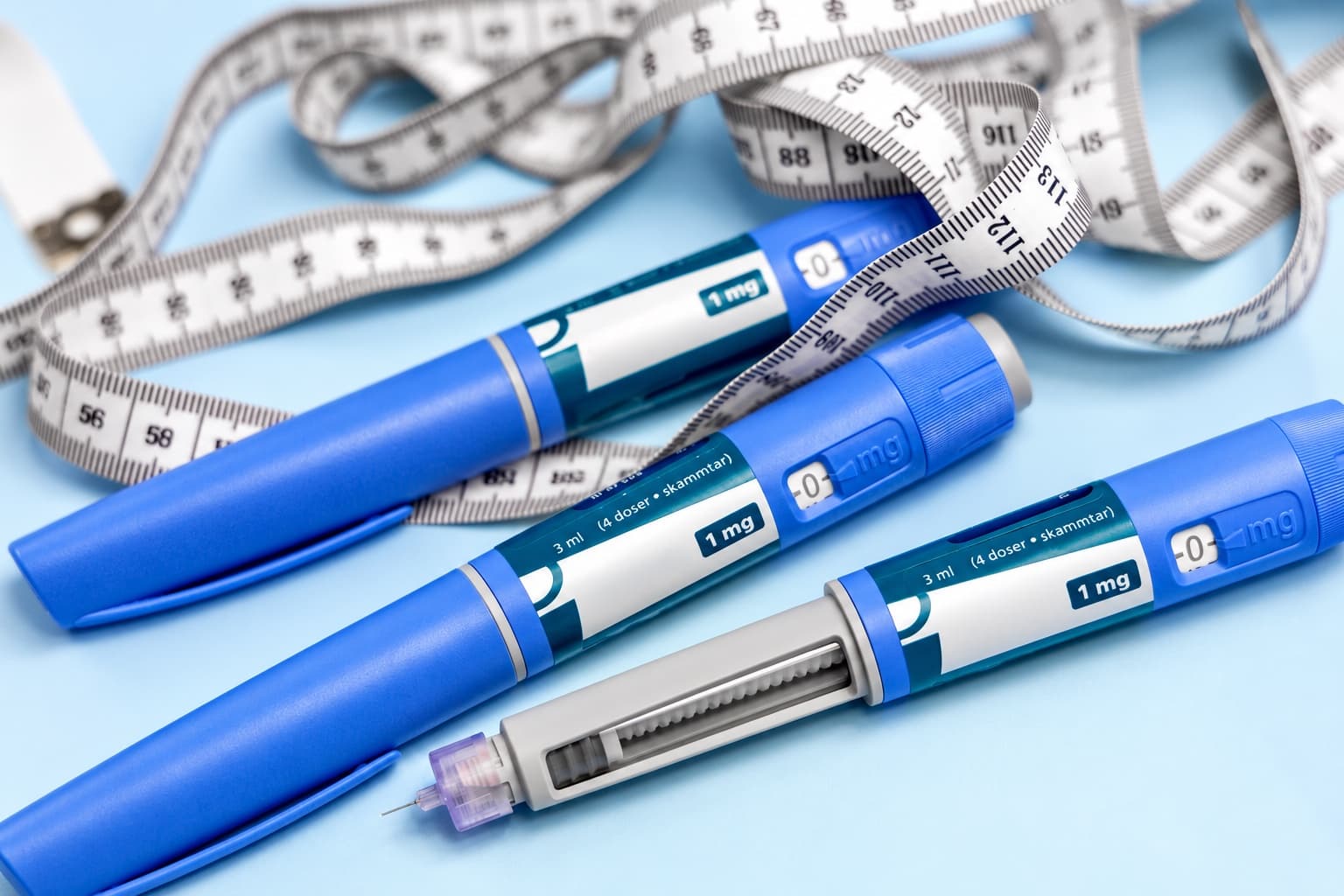 Injection pens beside a tape measure