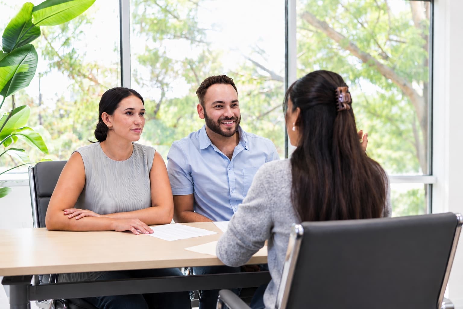 A couple in a consultation with a clinician across a desk